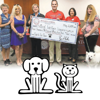 Roger D. Eaton, Clerk of the Circuit Court and County Comptroller presents Animal Welfare League with donation check