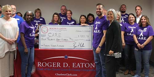 Roger D. Eaton, Clerk of the Circuit Court and County Comptroller presents the Center Abuse and Rape Emergencies with donation check